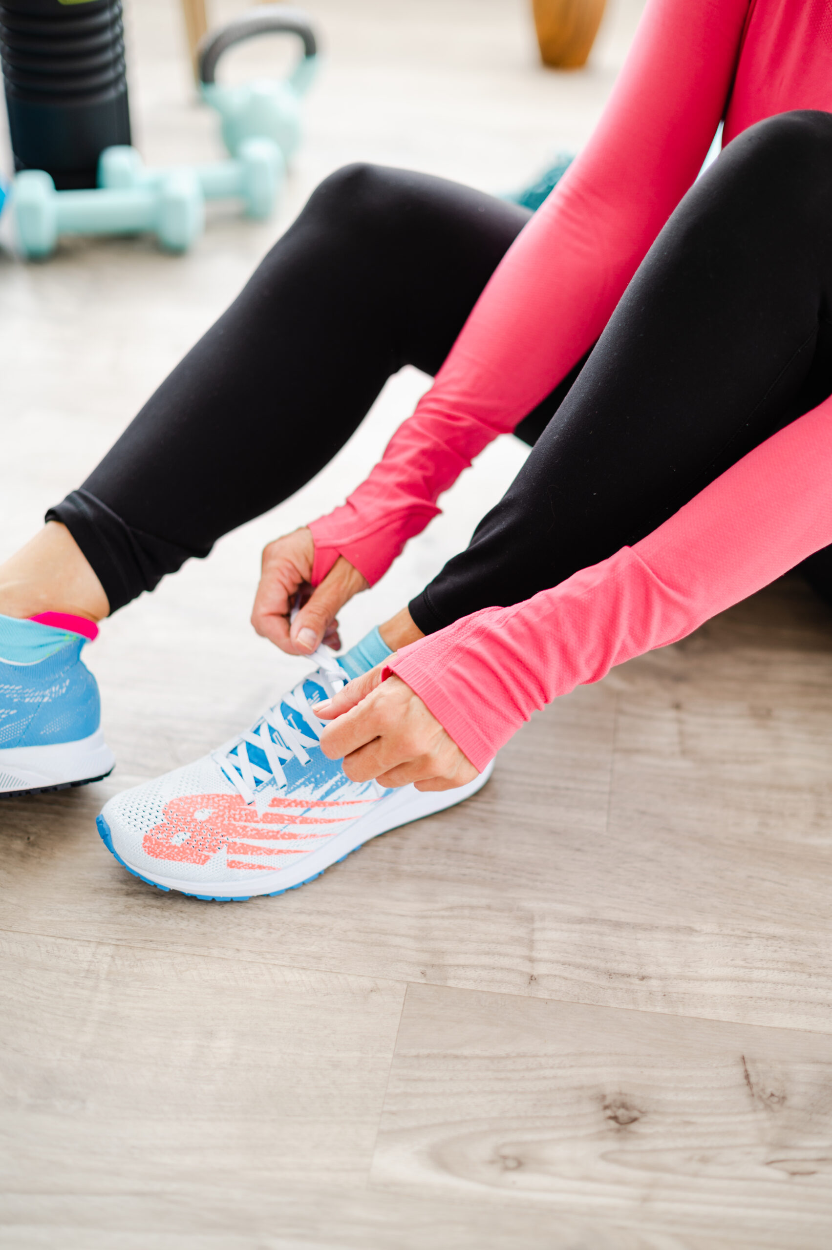 A woman tying her shoelace.